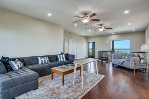 living room with dark hardwood / wood-style flooring and ceiling fan