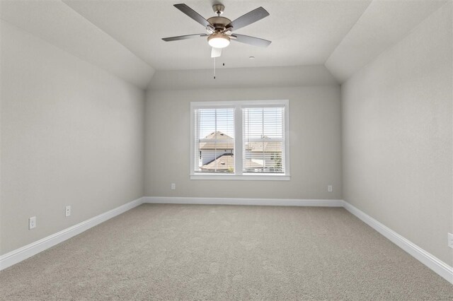 spare room with ceiling fan, carpet flooring, and vaulted ceiling