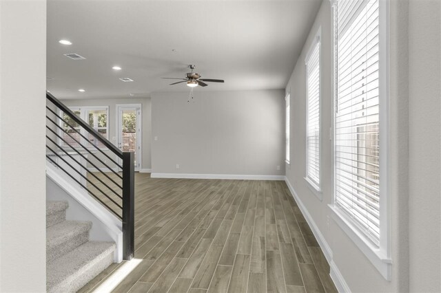 interior space with wood-type flooring and ceiling fan