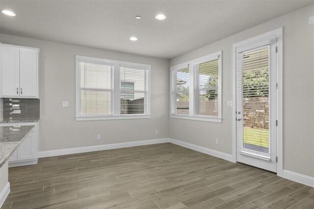 unfurnished dining area featuring hardwood / wood-style flooring