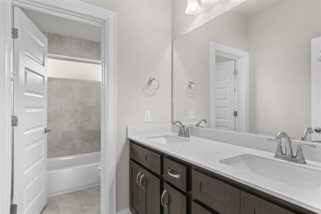 full bathroom featuring shower / tub combination, vanity, toilet, and tile patterned floors