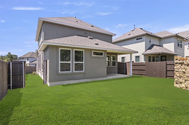 back of property featuring a yard and a patio area