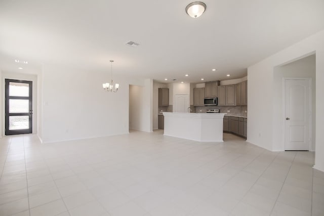 unfurnished living room with a notable chandelier