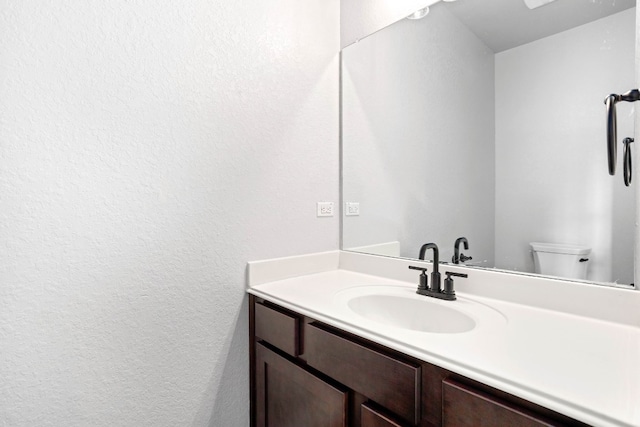 bathroom featuring toilet and vanity