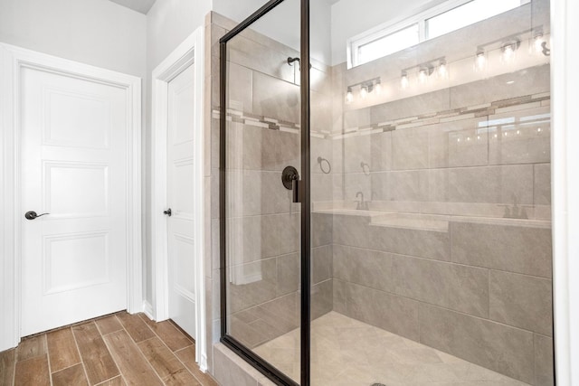 bathroom with walk in shower and hardwood / wood-style flooring