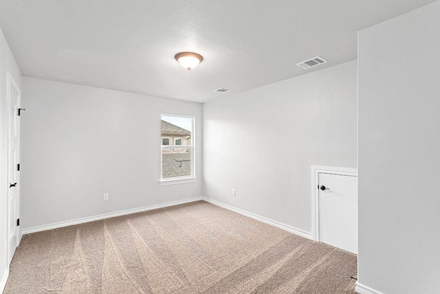 unfurnished room with light carpet