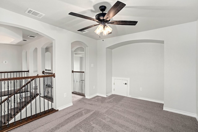 carpeted spare room featuring ceiling fan