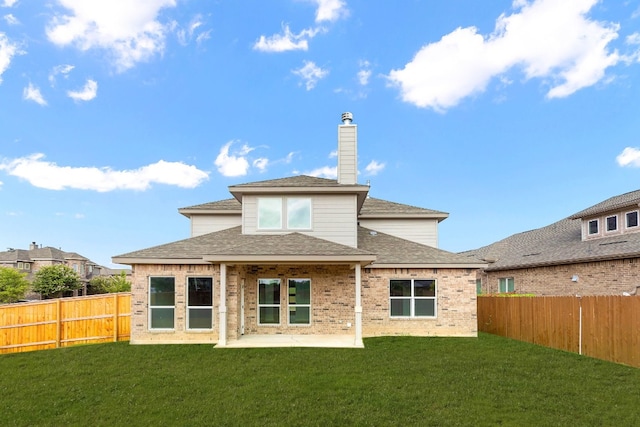 back of property featuring a patio and a lawn