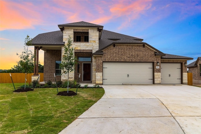 view of front facade featuring a yard and a garage