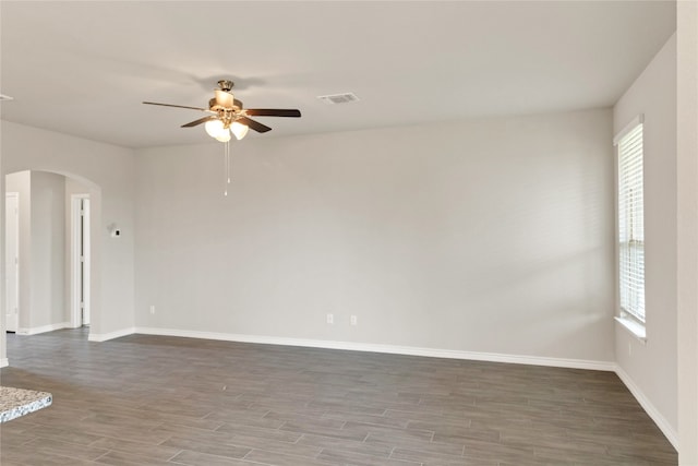 spare room featuring wood-type flooring and ceiling fan