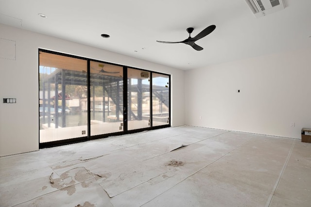 empty room with a healthy amount of sunlight, concrete floors, visible vents, and ceiling fan