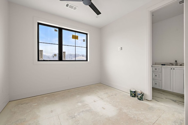 unfurnished room with ceiling fan, a sink, visible vents, and baseboards