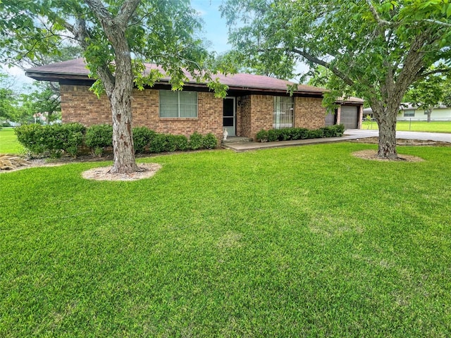 ranch-style house featuring a front yard and a garage