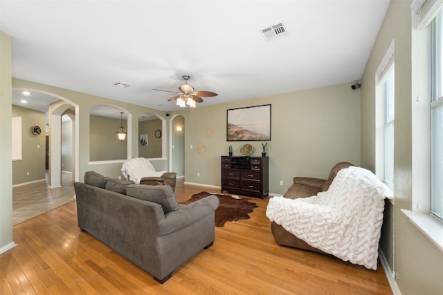 living room featuring ceiling fan and light hardwood / wood-style flooring