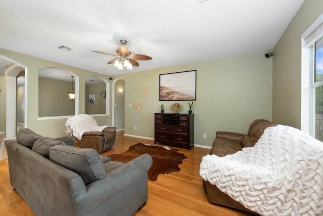 living room with ceiling fan and light wood-type flooring