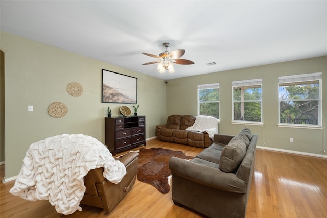 living room featuring ceiling fan and light wood-type flooring