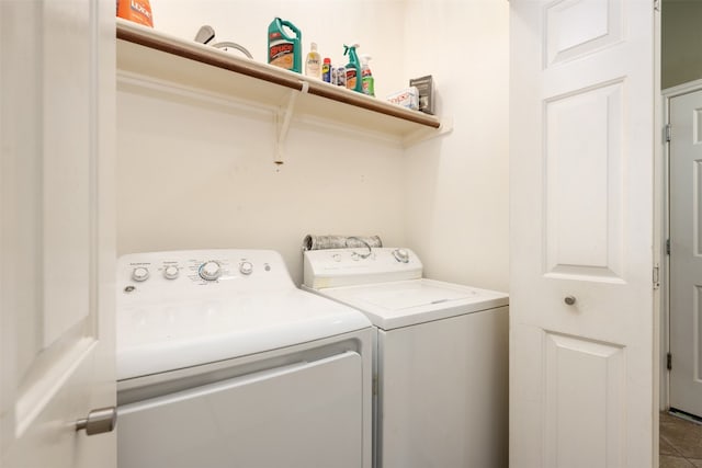 laundry room featuring tile flooring and washer and dryer