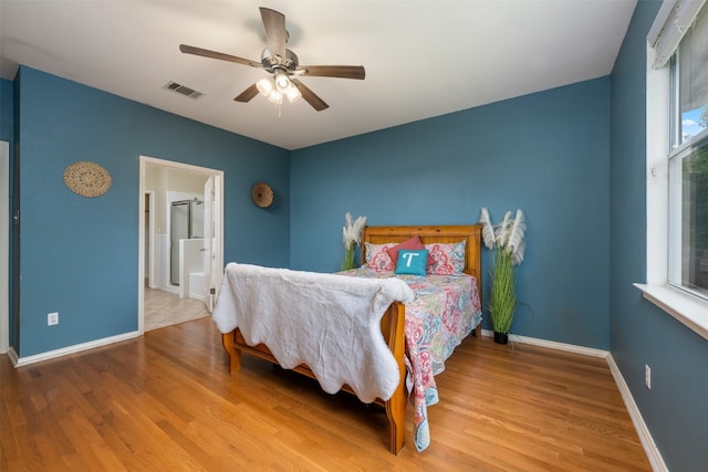 bedroom with light hardwood / wood-style floors and ceiling fan