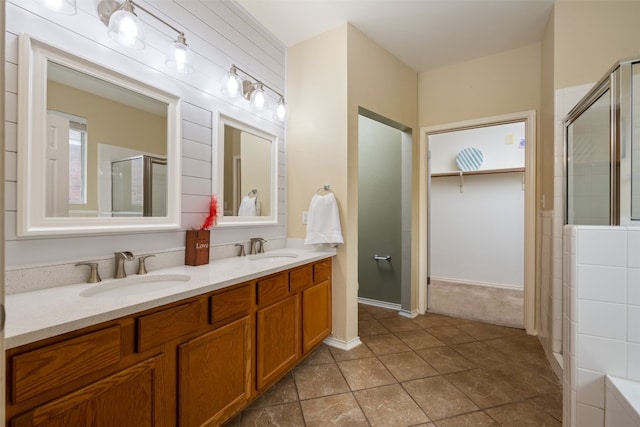 bathroom with double sink vanity, tile floors, and an enclosed shower