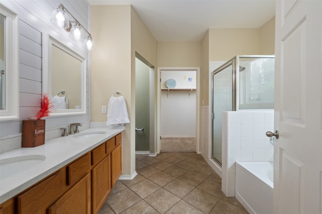 bathroom with shower with separate bathtub, dual sinks, oversized vanity, and tile flooring