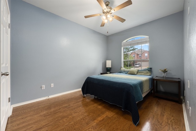 bedroom featuring ceiling fan and dark wood-type flooring