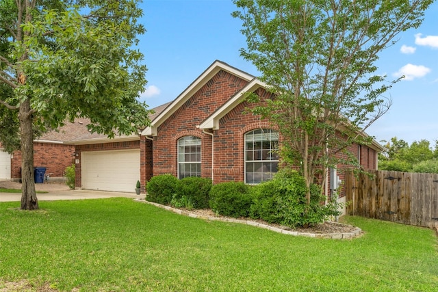 view of front of home featuring a front lawn and a garage