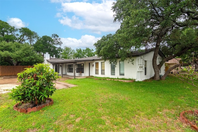 rear view of house with a yard