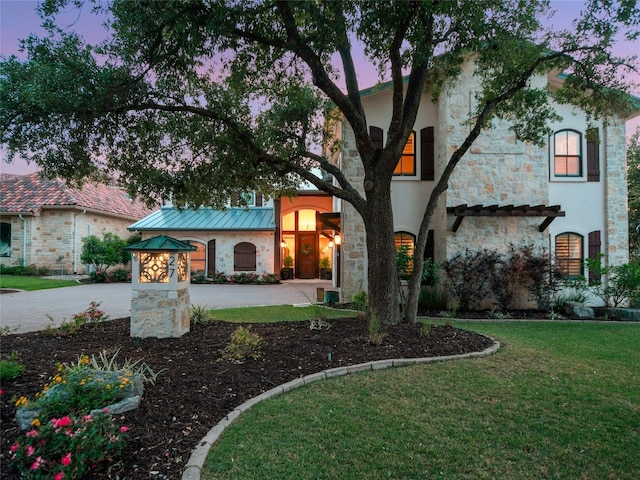 mediterranean / spanish house with a lawn and central air condition unit