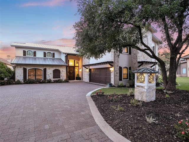 view of front of house with a garage and a lawn