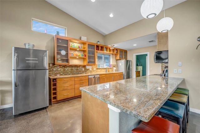 kitchen featuring kitchen peninsula, stainless steel appliances, light stone countertops, a kitchen bar, and lofted ceiling