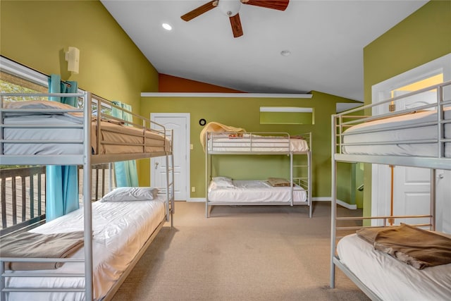 carpeted bedroom with ceiling fan and vaulted ceiling