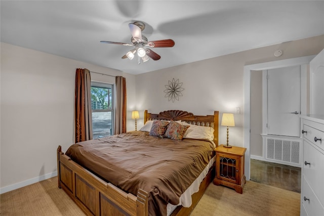 bedroom featuring light colored carpet and ceiling fan