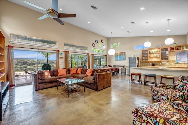 living room with high vaulted ceiling and ceiling fan