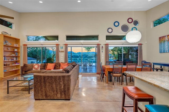 tiled living room with a high ceiling