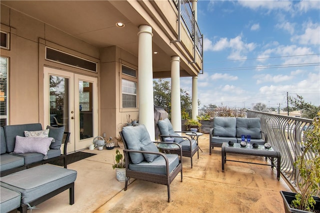 view of patio / terrace with a balcony, an outdoor hangout area, and french doors