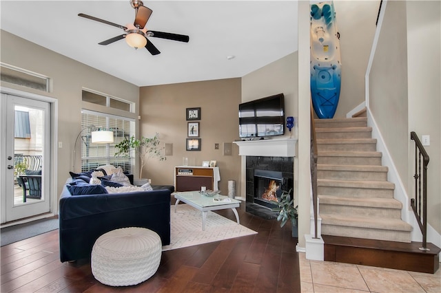 living room with hardwood / wood-style floors, a fireplace, and ceiling fan