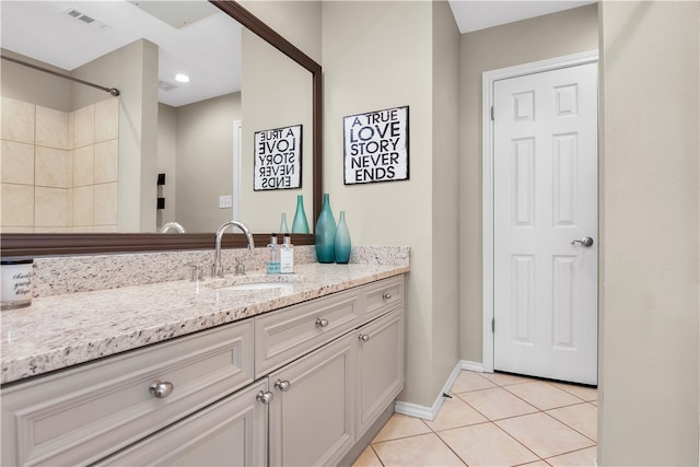 bathroom with vanity and tile flooring