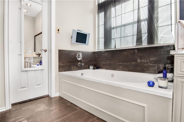 bathroom with tile flooring and a tub