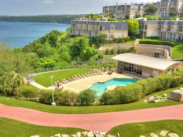 view of property's community with a swimming pool and a water view