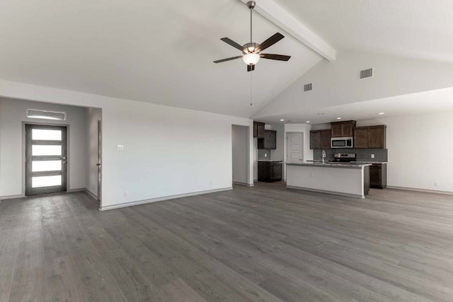 unfurnished living room featuring ceiling fan, beam ceiling, sink, high vaulted ceiling, and hardwood / wood-style flooring