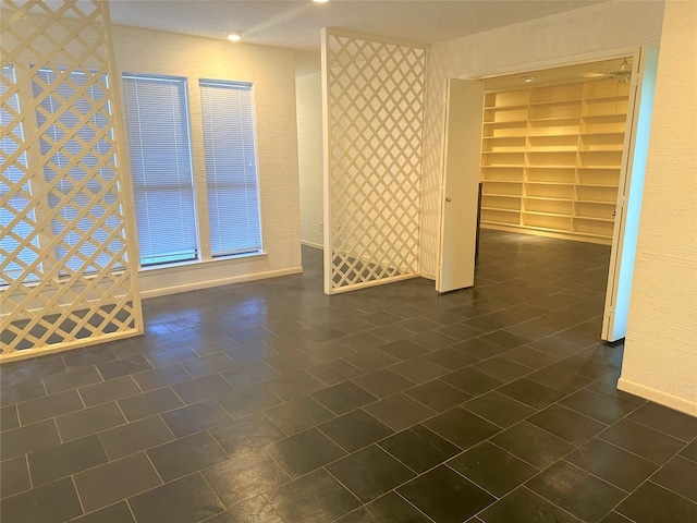 empty room featuring dark tile floors