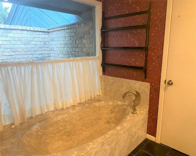 bathroom with a skylight, a bath to relax in, and tile floors