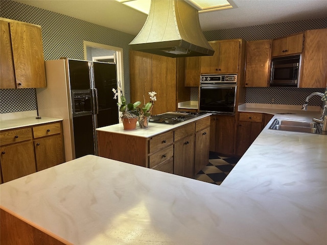 kitchen with appliances with stainless steel finishes, a center island, sink, tasteful backsplash, and extractor fan