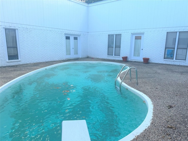 view of pool featuring a diving board