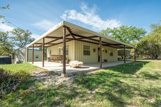 back of house with a yard and a patio