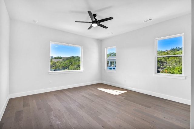 spare room with dark wood-type flooring and ceiling fan