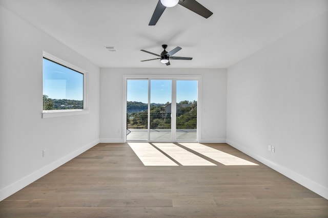 unfurnished room with light hardwood / wood-style flooring and ceiling fan