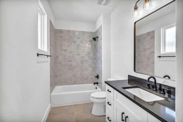 full bathroom featuring vanity, tiled shower / bath combo, tile flooring, and toilet