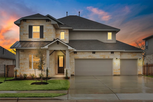 view of front facade featuring a garage and a lawn