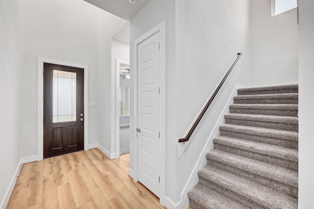 foyer entrance with a wealth of natural light and light hardwood / wood-style floors